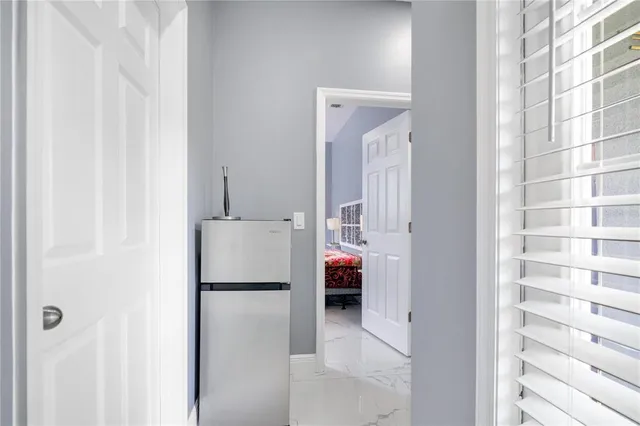 a walk in closet with wooden floor