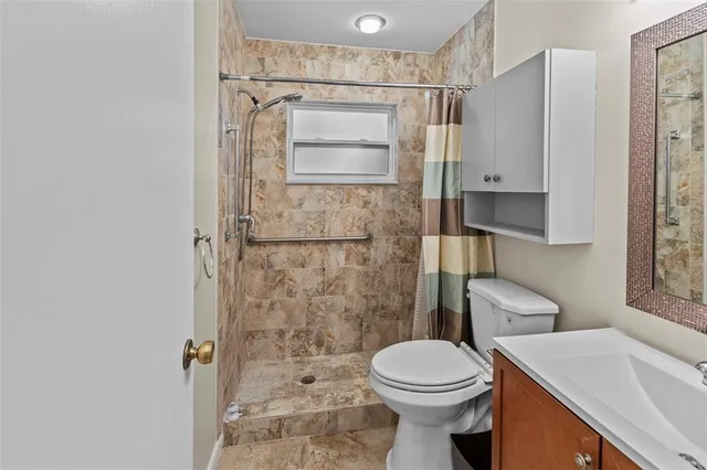 a bathroom with a sink toilet and shower