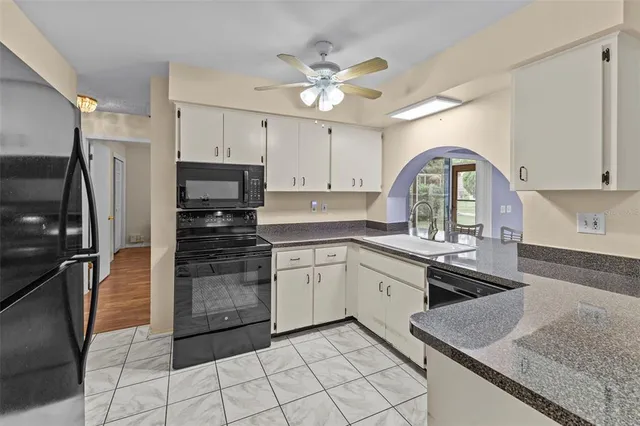 a kitchen with a sink stainless steel appliances and cabinets