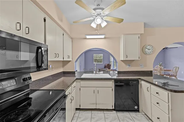 a kitchen with a sink stove and cabinets