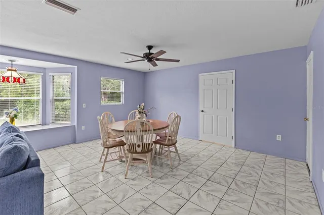 a view of a dining room with furniture and window