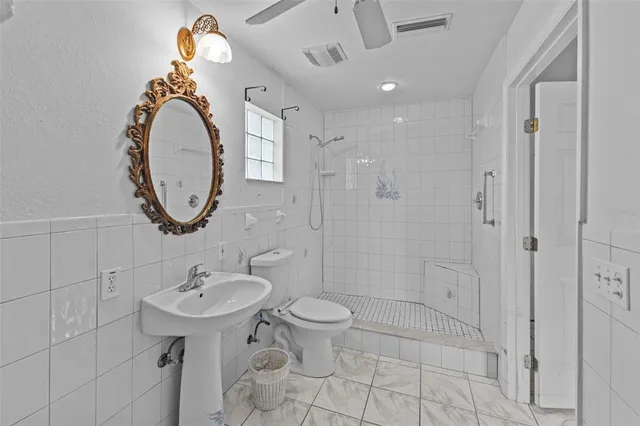 a bathroom with a sink mirror and toilet