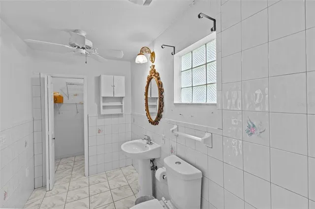 a bathroom with a shower a toilet and sink