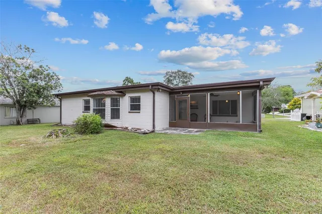 a view of a house with backyard and garden
