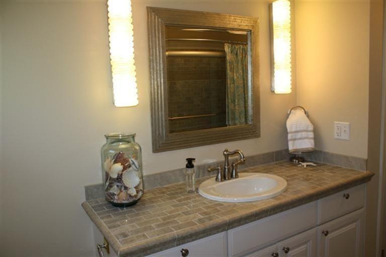 70 Gibson Road Orleans, MA 02653 - Photo 18 of 35 a bathroom with a granite countertop sink and a mirror