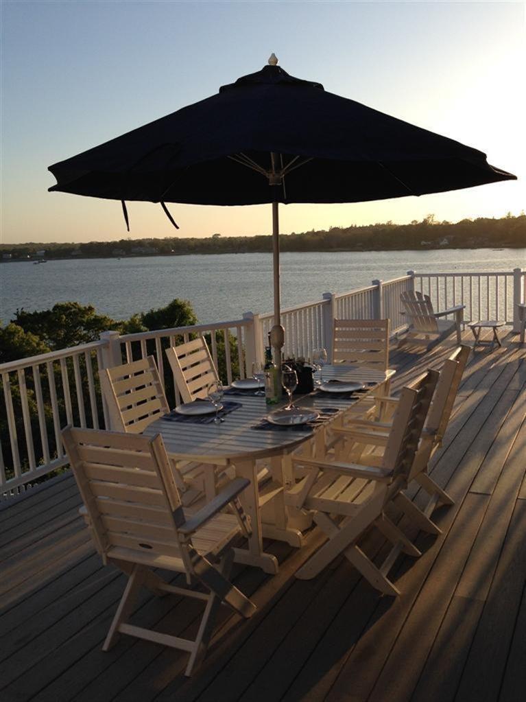 70 Gibson Road Orleans, MA 02653 - Photo 2 of 35 a view of a roof deck with dining table and chair