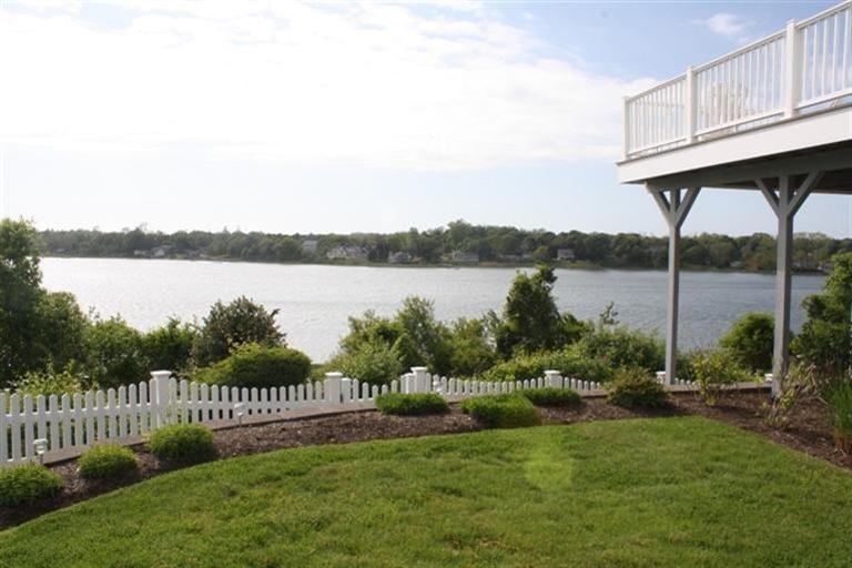 70 Gibson Road Orleans, MA 02653 - Photo 32 of 35 a view of a deck and lake with a big yard