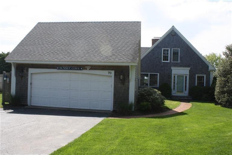 70 Gibson Road Orleans, MA 02653 - Photo 34 of 35 a front view of a house with a yard and garage