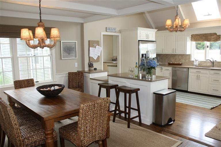 70 Gibson Road Orleans, MA 02653 - Photo 4 of 35 a kitchen with stainless steel appliances granite countertop a dining table chairs and a refrigerator