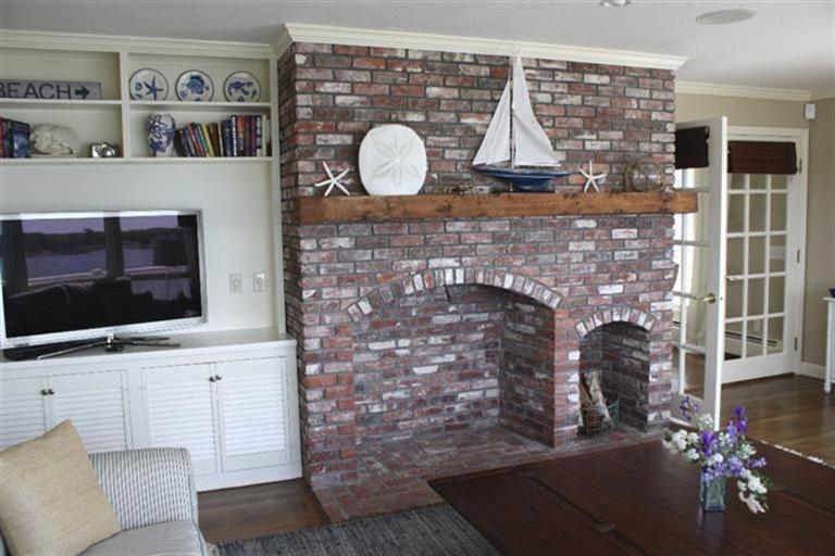 70 Gibson Road Orleans, MA 02653 - Photo 10 of 35 a living room with fireplace furniture and a flat screen tv