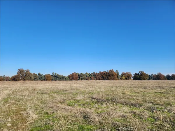 a view of an ocean with a table and chairs