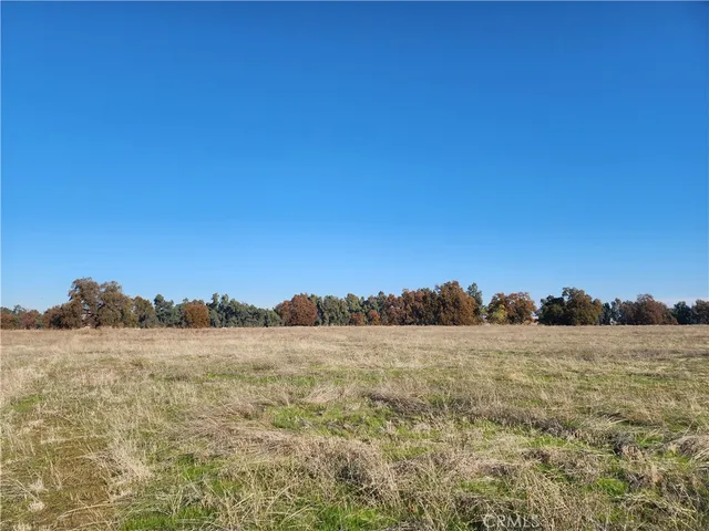 a view of an ocean with a table and chairs