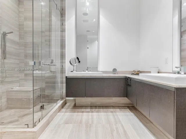 a large bedroom with a bed and large window