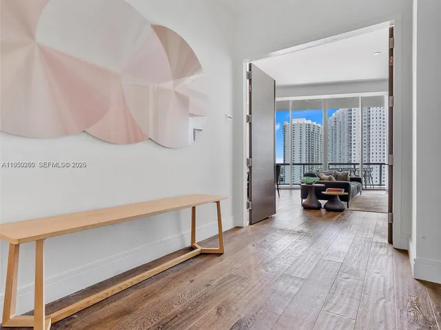 a view of living room with furniture and wooden floor