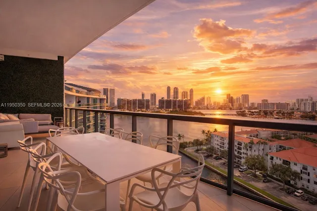a balcony with wooden floor and city view