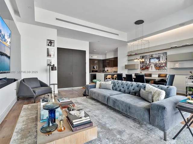 a kitchen with stainless steel appliances granite countertop a table chairs sink and cabinets