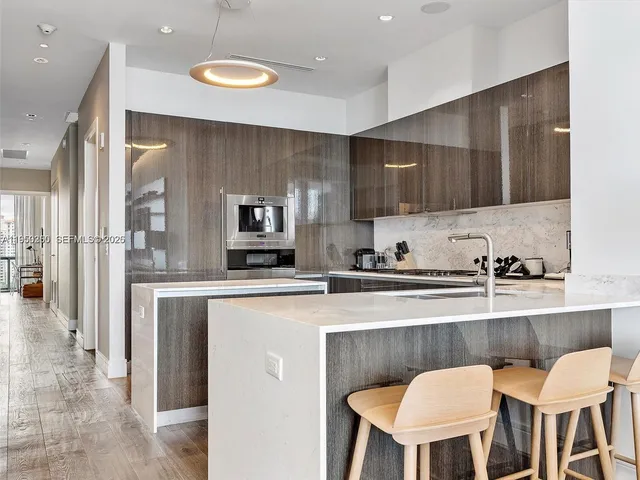 a kitchen with stainless steel appliances cabinets a sink and a stove