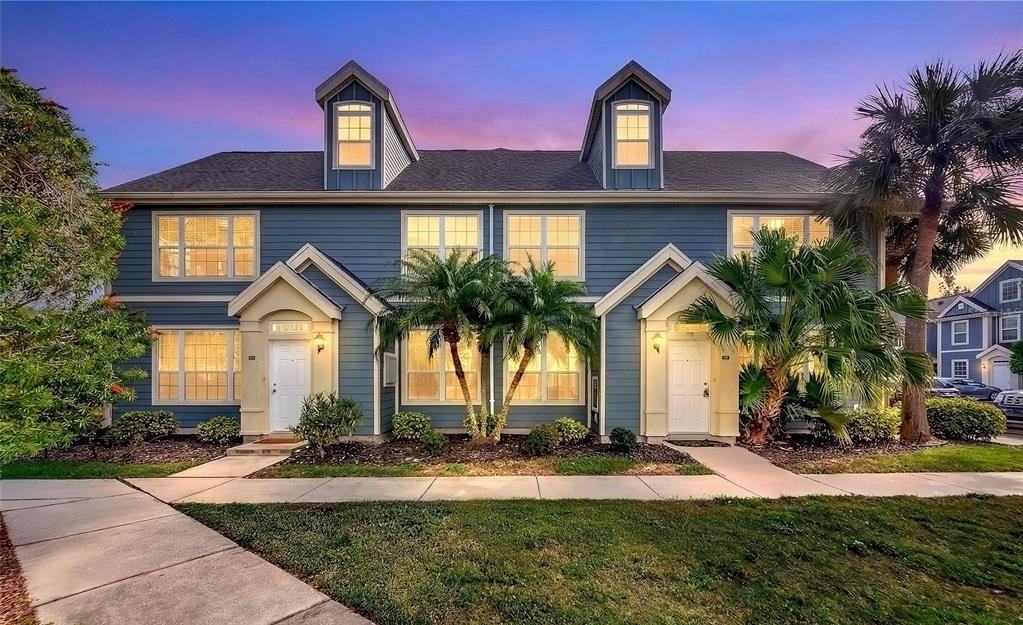 5560 Rosehill Road, Unit 201 Sarasota, FL 34233 - Photo 1 of 24 a front view of a house with a yard and garage