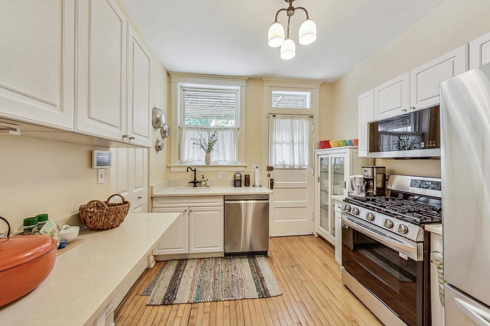 733 West Buckingham Place, Unit 13 Chicago, IL 60657 - Photo 10 of 28 a kitchen with a sink appliances cabinets and a window