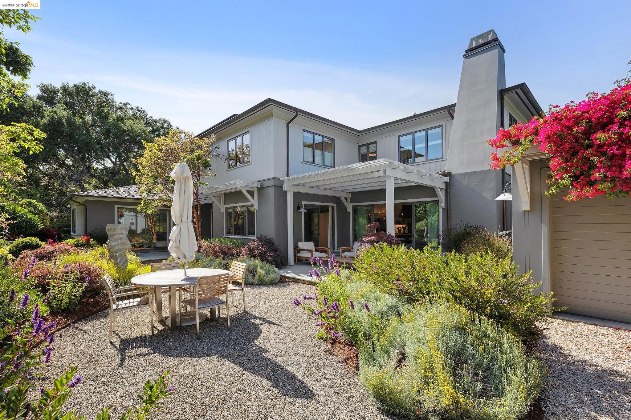 a front view of a house with a yard and sitting area