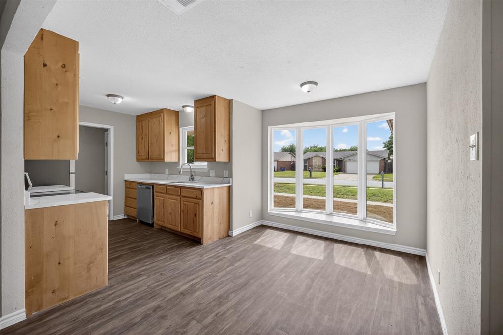 7528 Meadowlark Lane North Watauga, TX 76148 - Photo 11 of 31 a large white kitchen with a large window