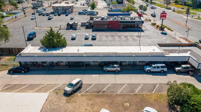a roof deck with table and chairs