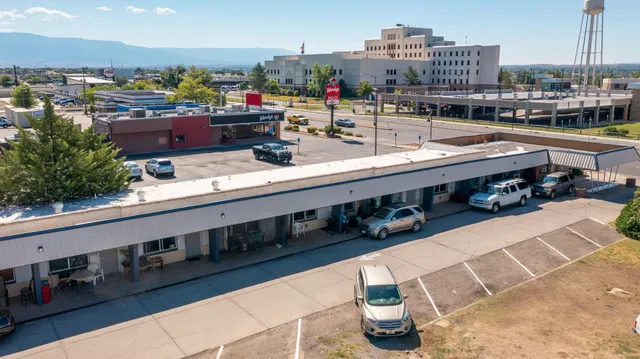 a view of a patio with table and chairs potted plants