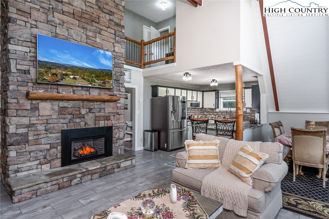 209 Apache Street Newland, NC 28657 - Photo 17 of 42 a living room with furniture and a fireplace
