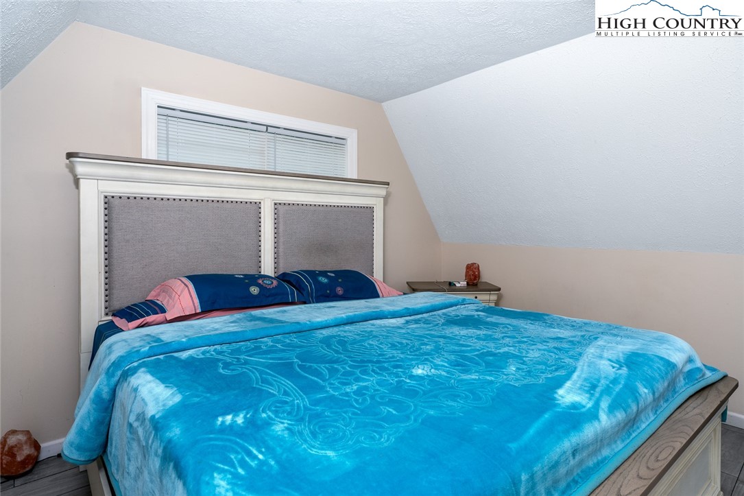 209 Apache Street Newland, NC 28657 - Photo 25 of 42 a bedroom with a bed and a window