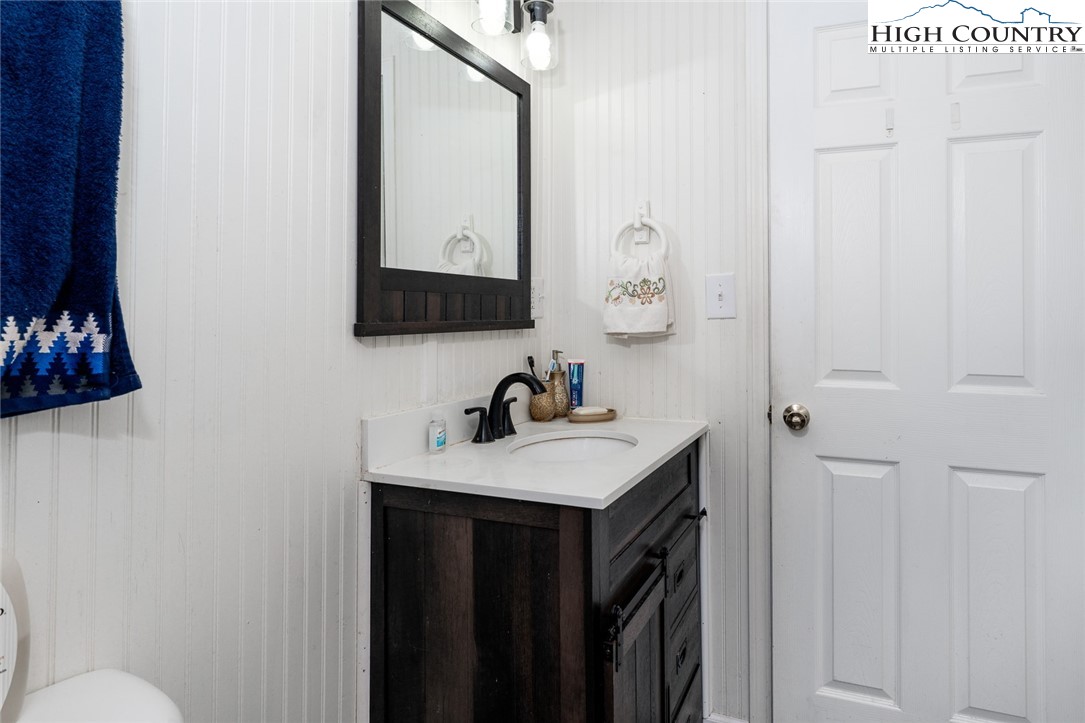 209 Apache Street Newland, NC 28657 - Photo 27 of 42 a bathroom with a sink vanity and a mirror