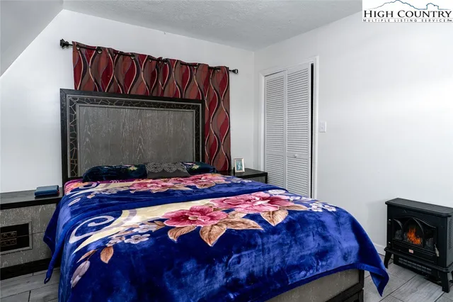 a bedroom with a bed and a mirror