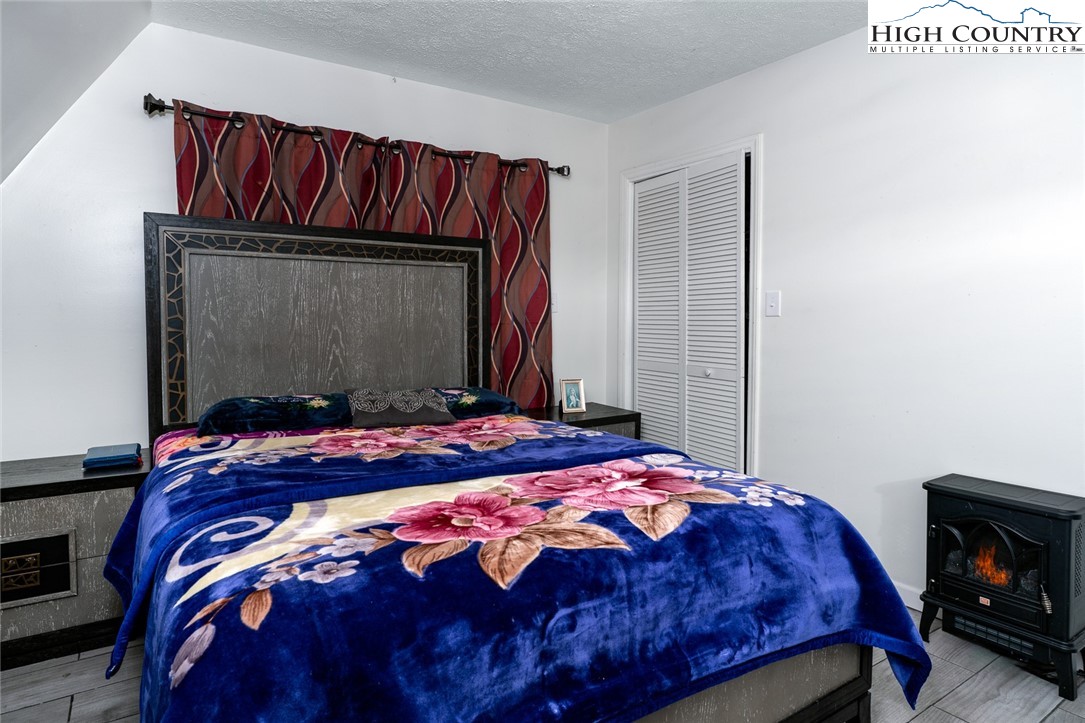 209 Apache Street Newland, NC 28657 - Photo 28 of 42 a bedroom with a bed and a mirror