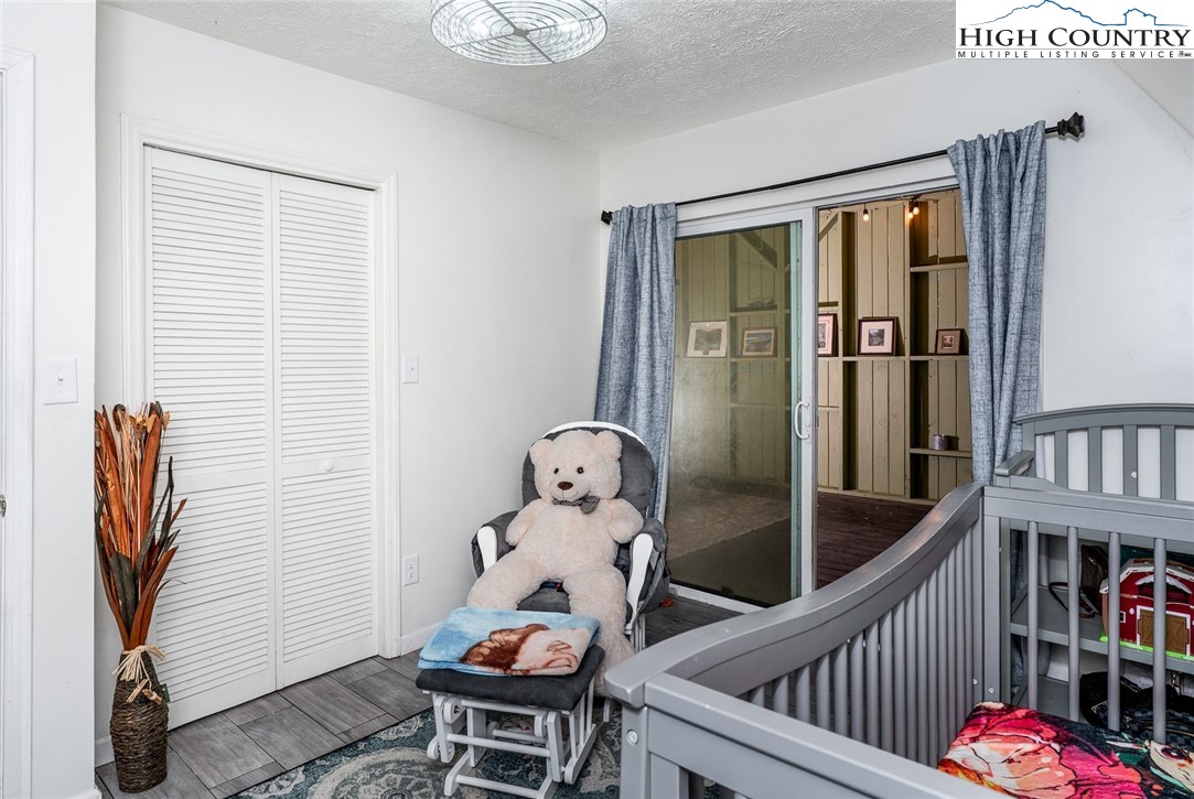 209 Apache Street Newland, NC 28657 - Photo 32 of 42 a view of a hallway with wooden floor and windows