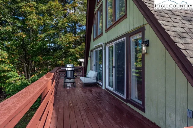 a view of balcony with chairs and wooden fence