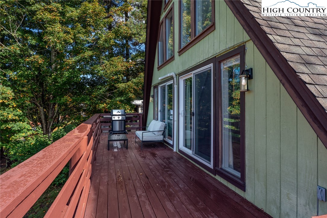 209 Apache Street Newland, NC 28657 - Photo 7 of 42 a view of balcony with chairs and wooden fence