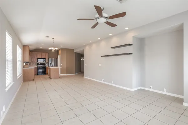 a view of a kitchen with a sink and a refrigerator