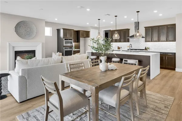 a view of kitchen with granite countertop cabinets table and chairs