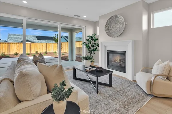 a living room with furniture a large window and a fireplace