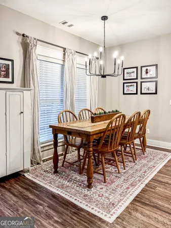 a view of a dining room with furniture window and wooden floor