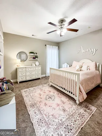 a bedroom with a bed and ceiling fan