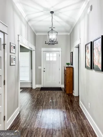 a view of a hallway with wooden floor and a window