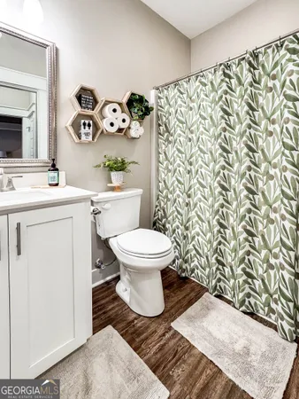 a bathroom with a toilet and a shower curtain