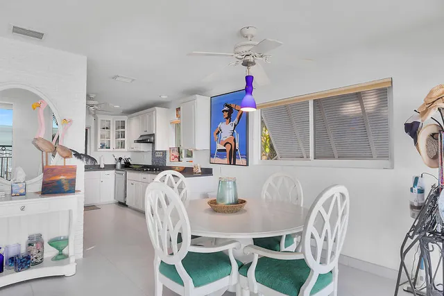 a view of a dining room with furniture and a chandelier
