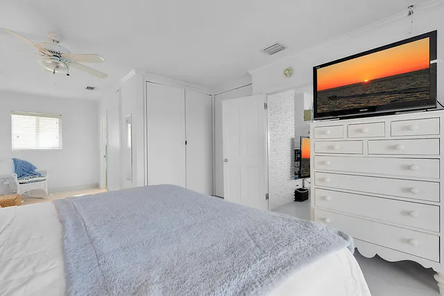 a bedroom with a bed and flat screen tv