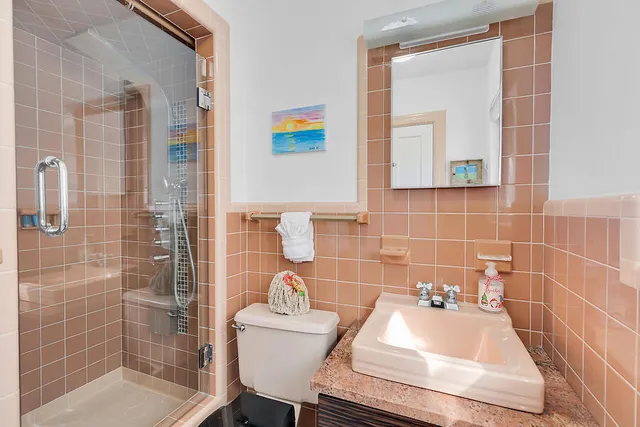 a bathroom with a sink toilet and shower