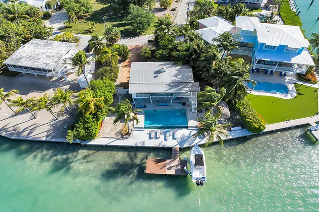 an aerial view of a house with a yard basket ball court and outdoor seating