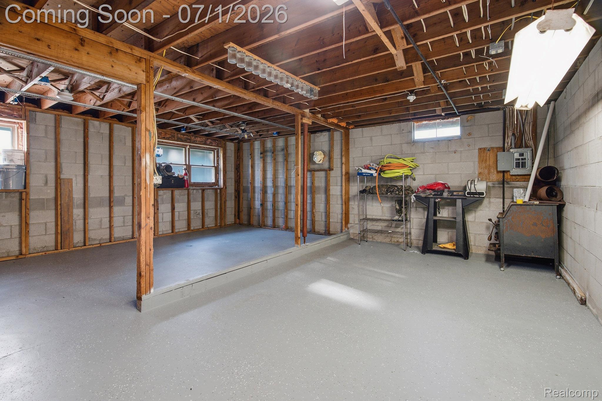 4762 Lonsberry Road Columbiaville, MI 48421 - Photo 25 of 36 Unfinished basement featuring concrete block walls, exposed wood ceiling joists, and a painted concrete floor