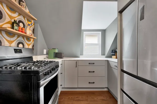 a kitchen with stainless steel appliances granite countertop a stove and a cabinet