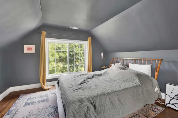 a bedroom with a large bed and a window