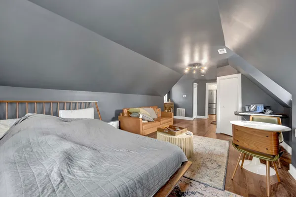 a large bedroom with a bed and furniture